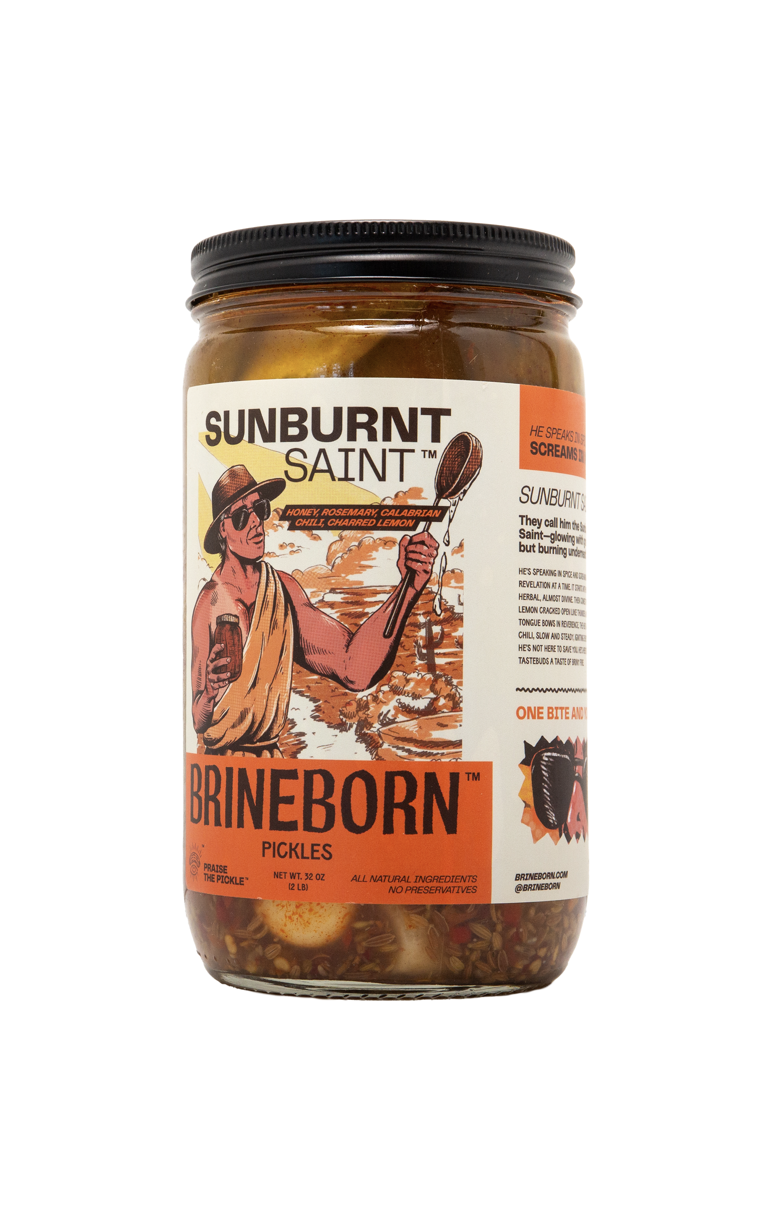 A glass jar of Brineborn "Sunburnt Saint" pickles featuring a black lid and a detailed, illustrated label against a transparent checkered background. The label depicts a man in a hat and sunglasses holding a drink against a coastal sunset background.