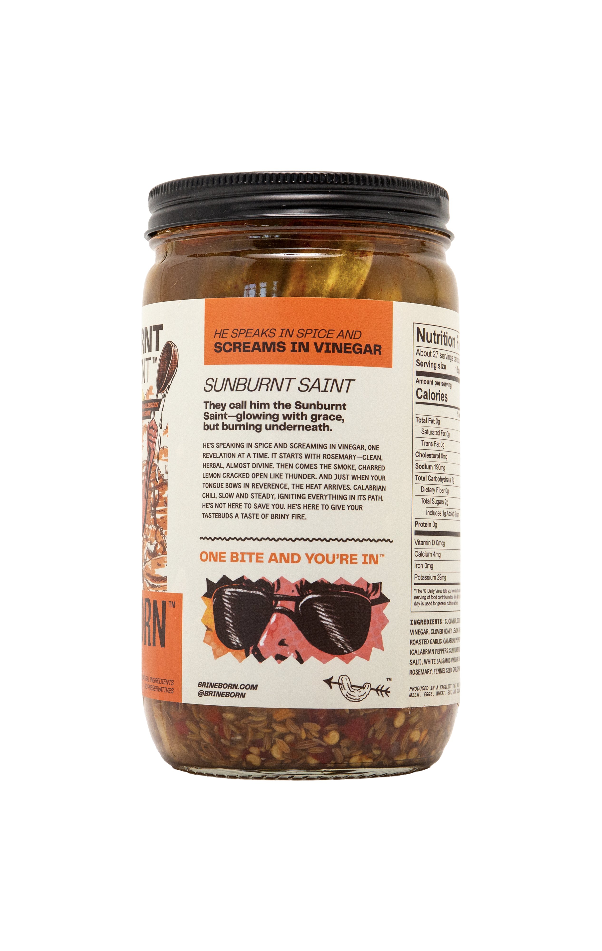 Side view of a Brineborn Sunburnt Saint pickle jar with an orange and white label showing product description text, nutrition facts, and a sunglasses illustration.